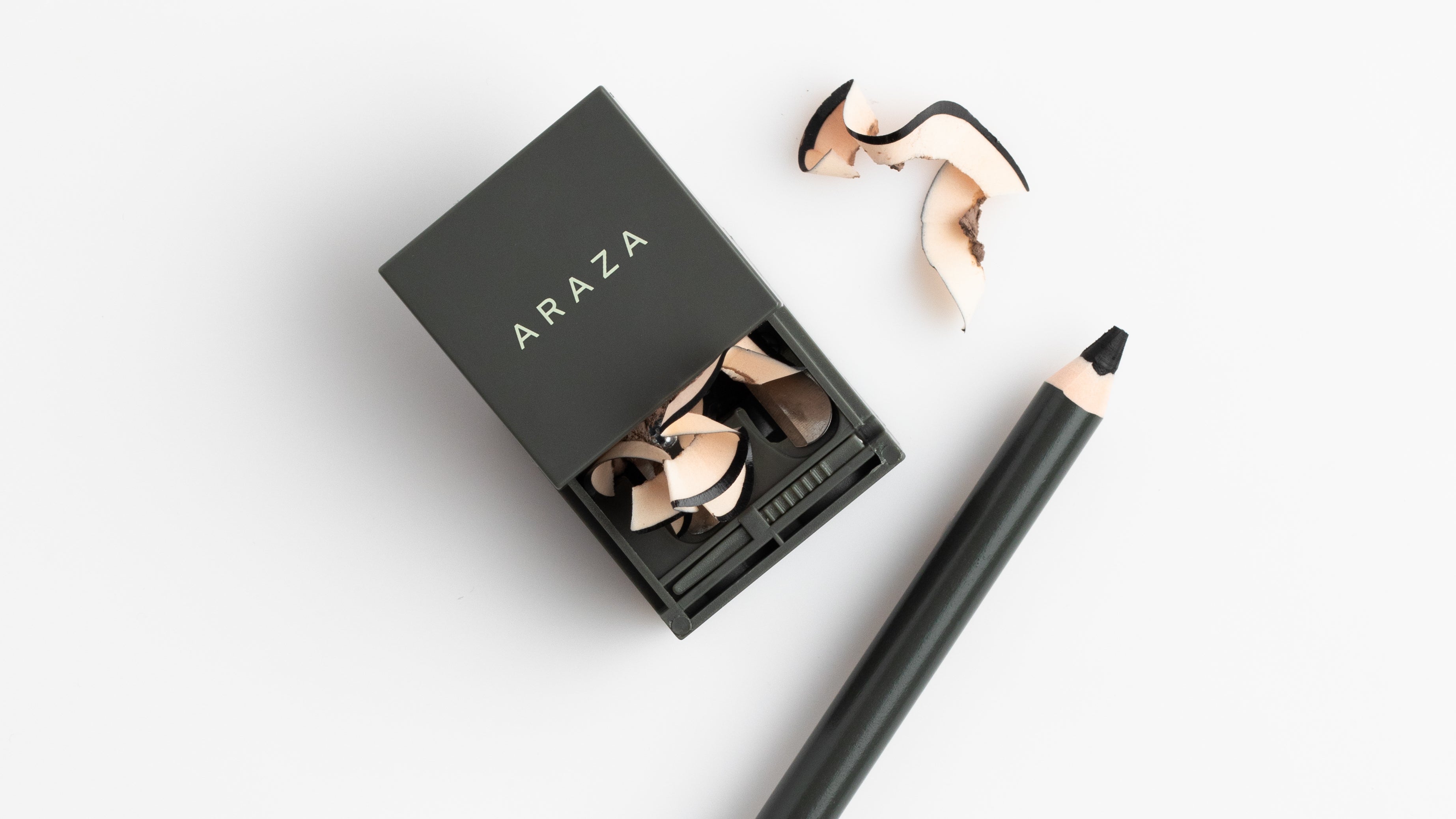 araza pencil sharpener with shavings next to the Avocado Butter Brow Pencil