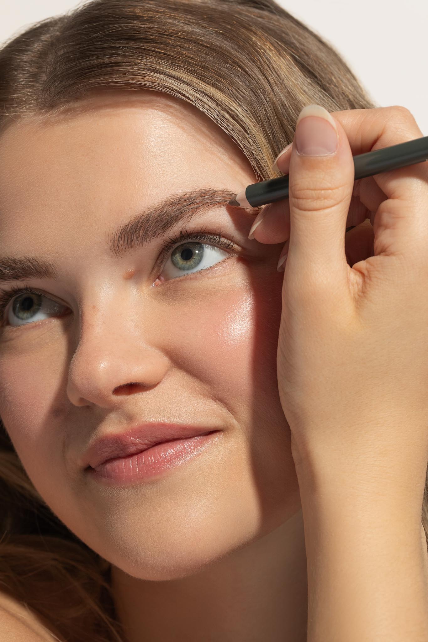 Woman applying Avocado Butter Brow Pencil